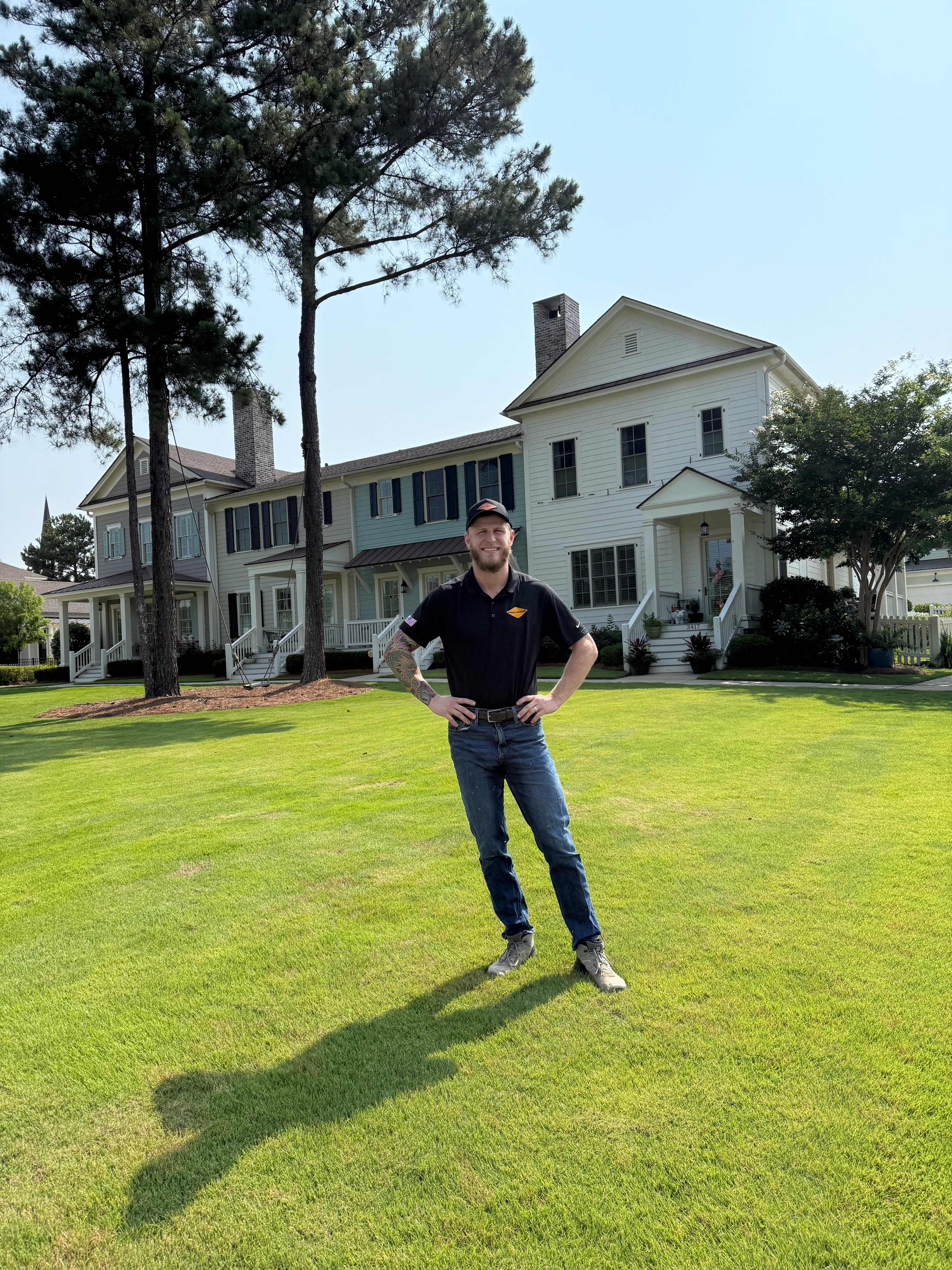 Owner of Summit Roofing Professionals in front of a completed residential project